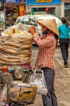 Lady loading bike-Saigon