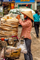 Lady loading bike-Saigon